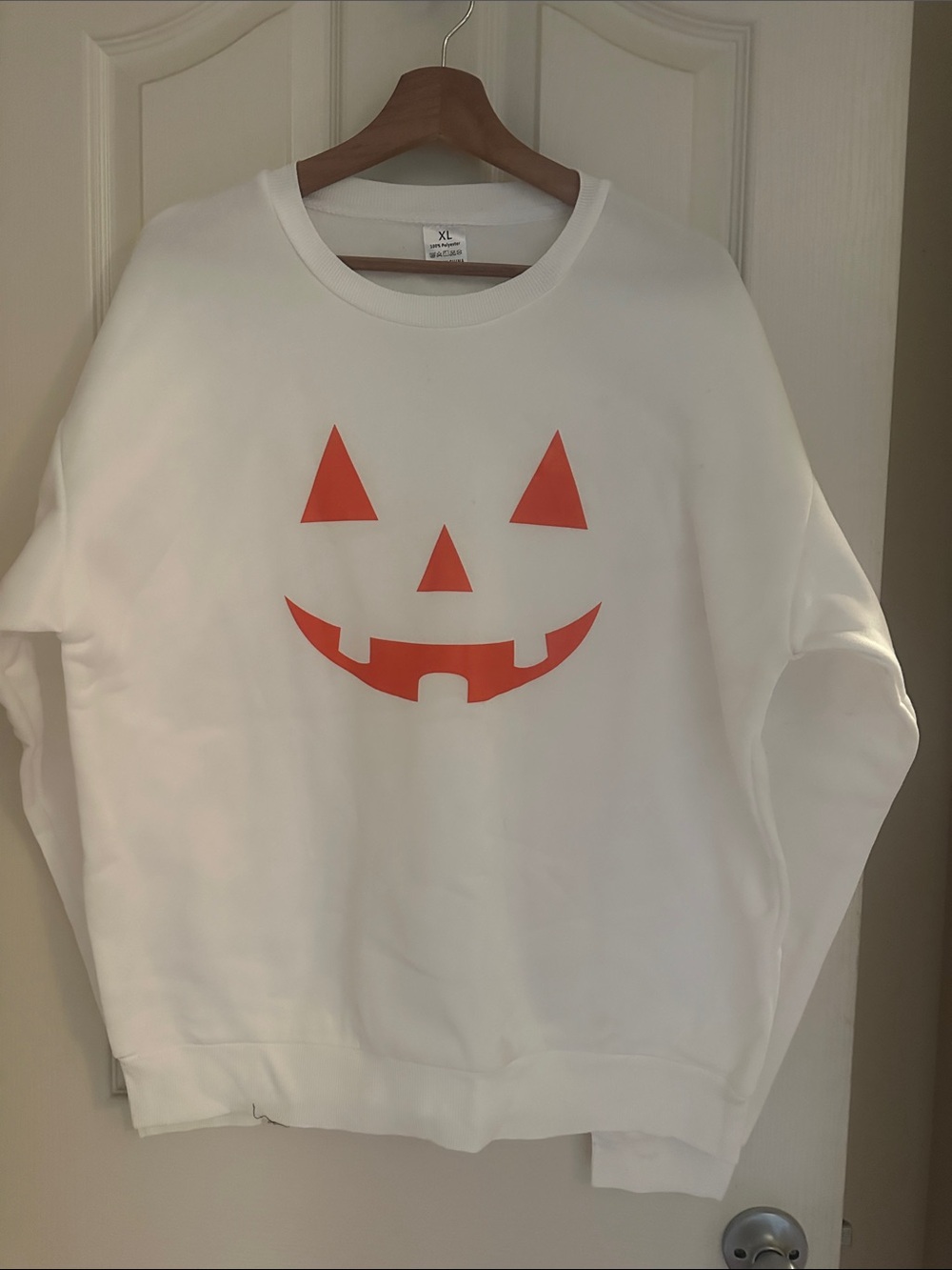 White Crewneck Sweatshirt with Orange Jack-O'-Lantern Graphic